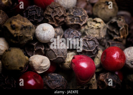 Multicolored peppercorn on a pile, macro photo Stock Photo