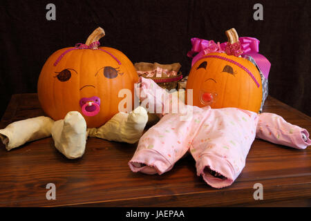 Two pumpkins dressed up as princess babies with pacifiers. Stock Photo