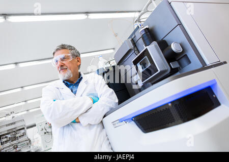 Renowned scientist/doctor in a research center/hospital laboratory looking confident (color toned imageł; shallow DOF) Stock Photo