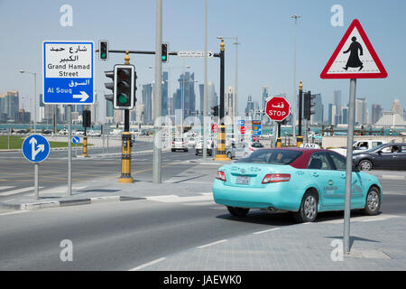 A turquoise taxi at a road junction of Al Asmakh Street and Abdullah Bin Jassim Street in Doha, Qatar. Stock Photo