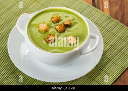 cream soup puree of green peas with croutons Stock Photo