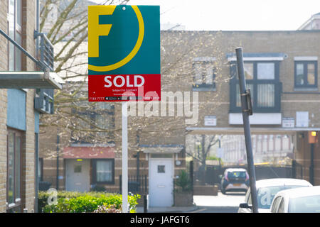 London, UK - March 27, 2017 - Estate agency sold sign outside a English townhouse Stock Photo