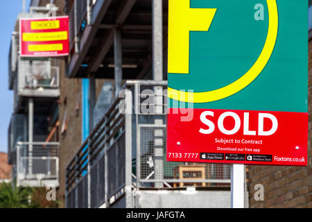 London, UK - March 27, 2017 - Estate agency sold sign outside a English townhouse Stock Photo