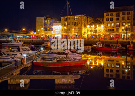 Long exposure photograph of moored boats and yachts in the Barbican harbour area at Plymouth on a Saturday night. Stock Photo