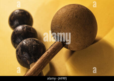African rattle instrument isolated on yellow background Stock Photo