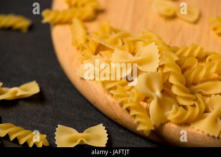 Variety of types and shapes of dry Italian pasta on dark background Stock Photo