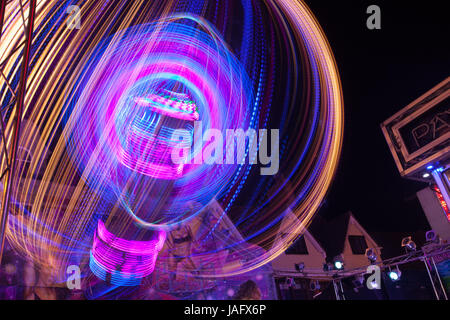 Light trace from the 'Body Count' funfair ride at Banbury's Michaelmas Street Fair. Stock Photo