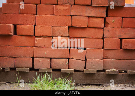 Stack of red bricks on a building site. Stock Photo
