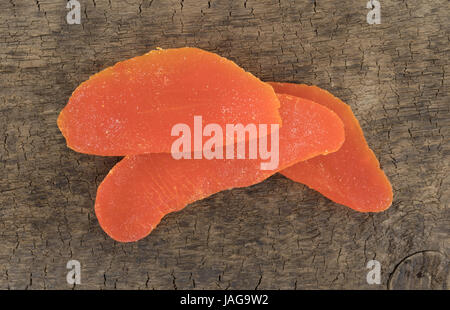 Dried mango slices on an old wood board. Stock Photo