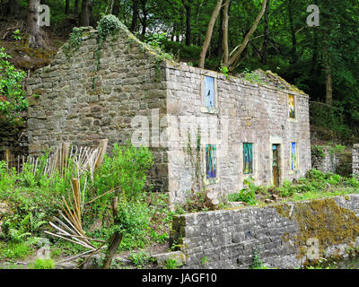 Abandoned building on Cromford Canal, Derbyshire, with painted windows Stock Photo