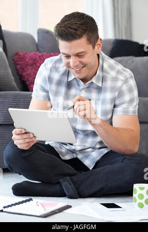 Male Freelance Designer Using Digital Tablet At Home Stock Photo