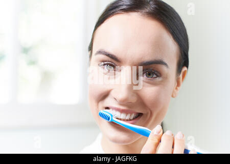 Woman Brushing Teeth With Toothbrush In Bathroom Stock Photo