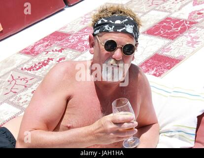 An englishman with a beard wearing a bandana and cool sunglasses while on vacation, 2017 Stock Photo