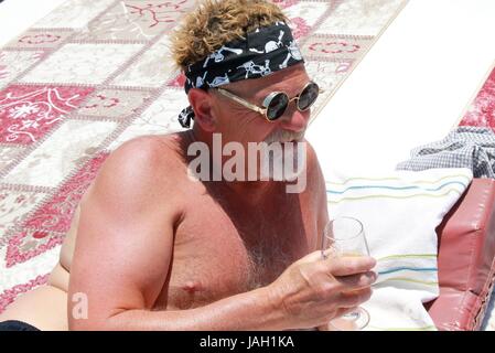 An englishman with a beard wearing a bandana and cool sunglasses while on vacation, 2017 Stock Photo