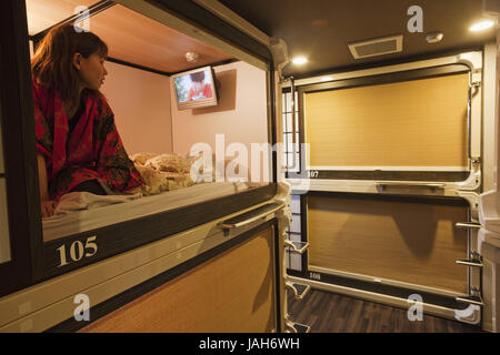 Japan,Kyoto,Ryokan capsule hotel,girl in the room, Stock Photo