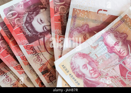 Piles of Great British currency including cash and coins in sterling. Stock Photo