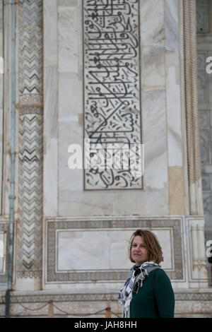 tourist in front of the scriptures on the Mausoleum of Taj Mahal, Agra, State of Uttar Pradesh, India Stock Photo