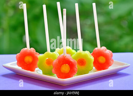 fruit pops of melon and watermelon on natural background Stock Photo