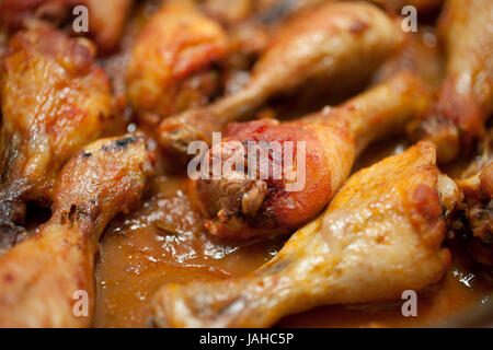 Closeup of cooked chicken legs in a tray. Stock Photo