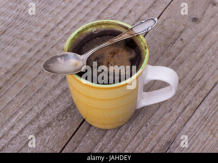 Yellow cup with freshly brewed coffee Stock Photo