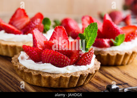 Strawberry shortcake pies on rustic wooden table,  perfect party individual fresh fruit dessert Stock Photo