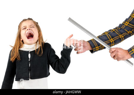 Young girl being physically punished by teacher with a ruler Stock Photo