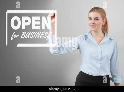 open for business sign hand drawn on to the screen by businesswoman Stock Photo