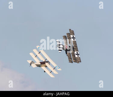 A Sopwith Triplane and a Fokker Triplane of the Great War Display Team in a mock dogfight at a Duxford air show Stock Photo