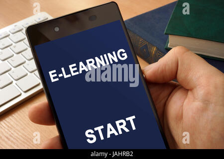 Hand with smartphone  and app E-learning. Distance education concept. Stock Photo