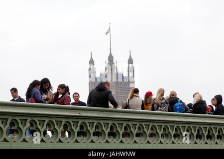 London, United Kingdom, 6 may 2017: people on westminster bridge with tower of houses of parliament behind them. Stock Photo