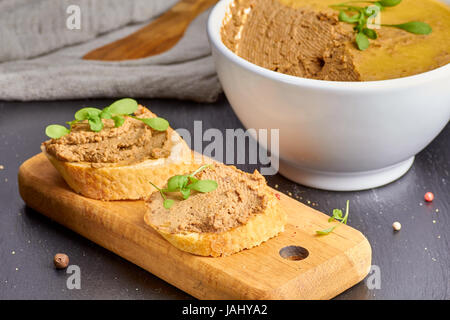 Pieces of baguette with chicken liver pate Stock Photo