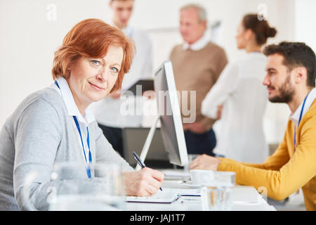 Senior business woman taking notes for strategy planning Stock Photo