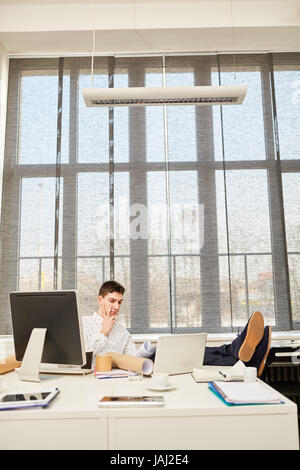 Entrepreneur sitting and thinking about business decision and planning Stock Photo
