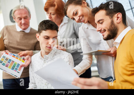 Young designers in brainstorming workshop in business start-up Stock Photo