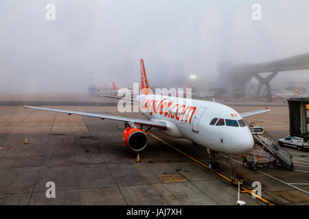 A Easy Jet Plane On The Ground In The Fog At London Gatwick Airport, West Sussex, UK Stock Photo