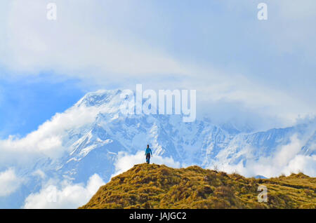 Young woman admires by Annapurna South Peak. Mountain Landscape in Annapurna region Stock Photo