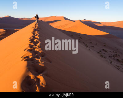 SOUSSUSVLEI, NAMIBIA - JUNE 20, 2016: People watching sunrise form the Dune 45 in the Sossusvlei area of the Namib Desert in Namibia. Stock Photo