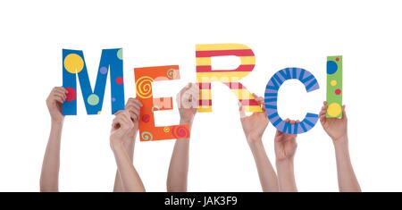 Many Hands Holding the Colorful French Word Merci, Which Means Thanks, Isolated Stock Photo