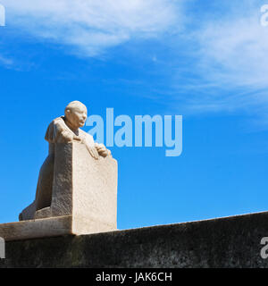 statue kneels and prays in the confessional Stock Photo