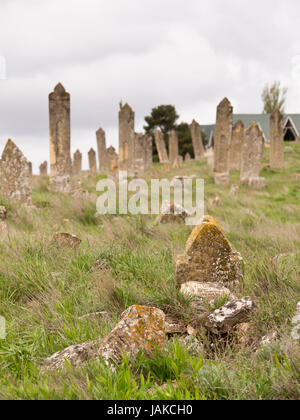 Local cemetery in the town of Maraza, Gobustan Azerbaijan, old graves with leaning gravestones and lichen Stock Photo