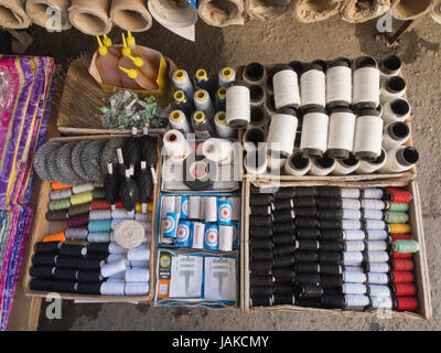 The daily outdoors market in Şəki (transcribed Shaki or Sheki) in northern Azerbaijan offers spools of sowing thread and accessories for clothesmaking Stock Photo
