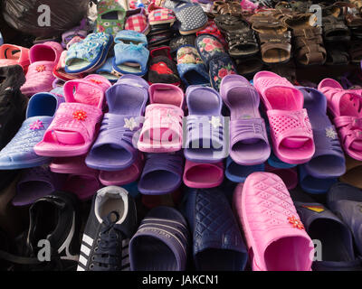 The daily outdoors market in Şəki (transcribed Shaki or Sheki) in northern Azerbaijan offers colourful plastic slippers and sandals in pink and purple