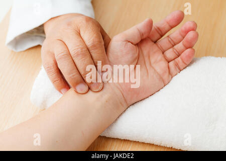 Chinese doctor diagnose pulse of patient Stock Photo