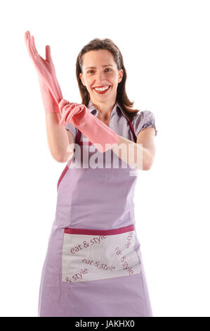 Hausfrau, Putzfrau mit langen dunkelblonden Haaren und Küchenschürze bei der Hausarbeit vor weißem Hintergrund. Stock Photo