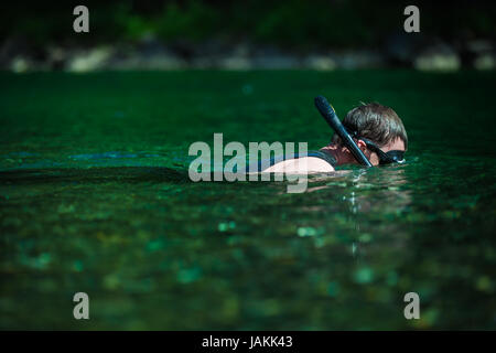 Young Adult Snorkeling in a river with Goggles and Scuba. Stock Photo