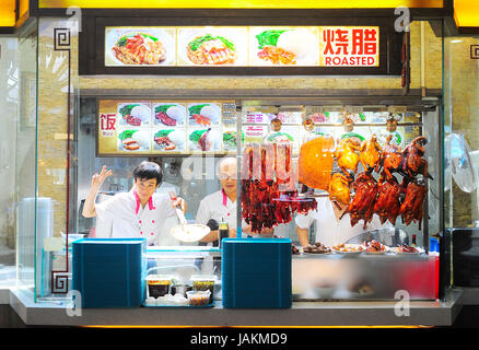 Singapore, Republic of Singapore - March 06, 2013: Food stall in Singapore. Inexpensive food stalls are numerous in the city so most Singaporeans dine out at least once a day. Stock Photo