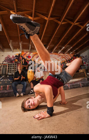 Young female capoeira performer kicking from the ground Stock Photo