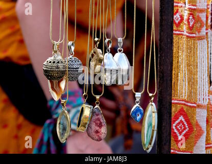 Handcrafted  artisan necklaces with semi-precious stones, silver pewter and gold jewellery  for sale on an international market stall at a festival Stock Photo