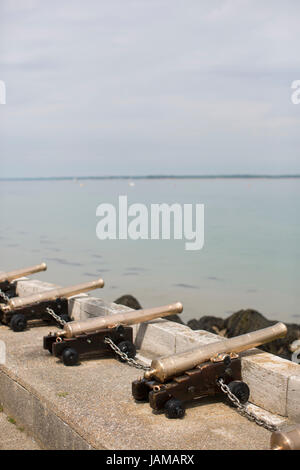 Ceremonial cannons point out towards the Solent outside the Royal Yacht Squadron in Cowes, Isle of Wight. Stock Photo