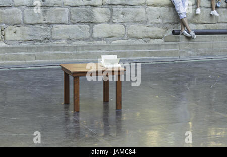 Table with book open urban square, reading and entertainment Stock Photo